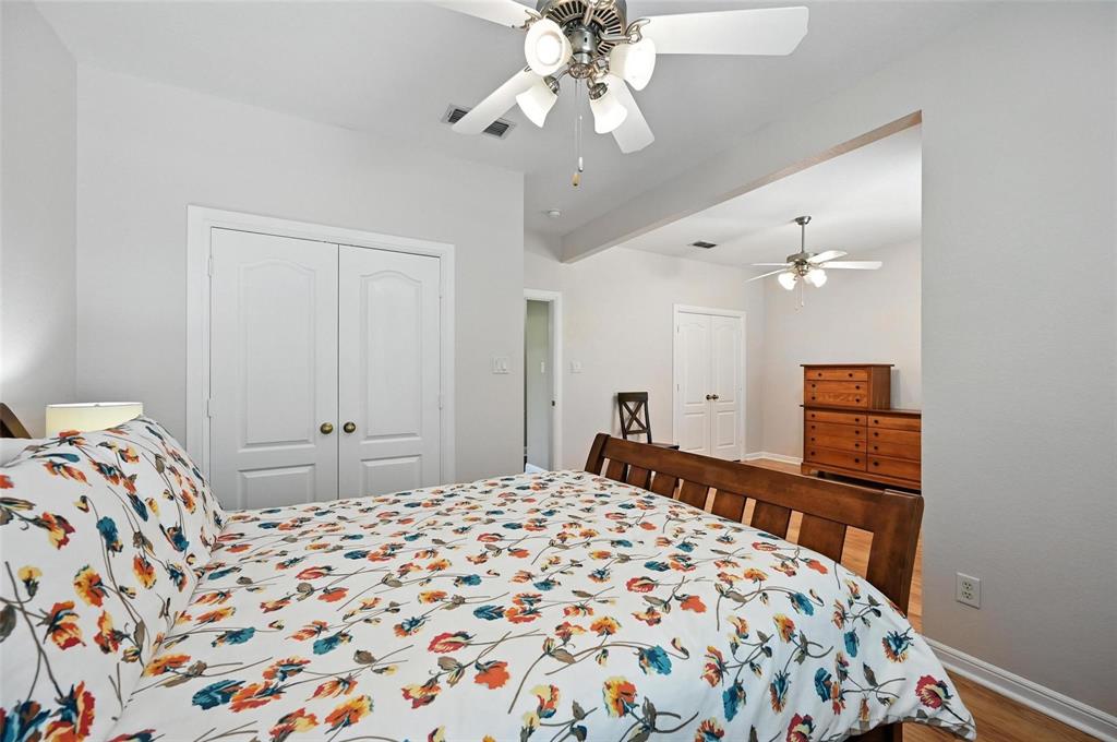 8974 Ranch Bluff Court Benbrook, TX 76126 - Photo 25 of 37 a bedroom with a bed and wooden floor