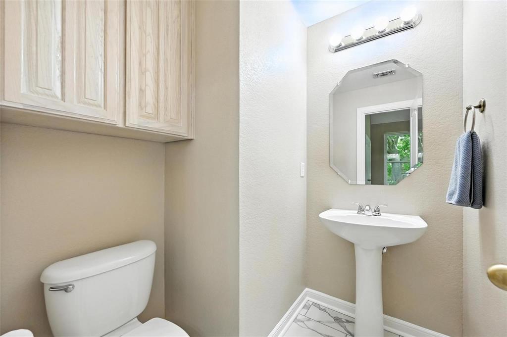 8974 Ranch Bluff Court Benbrook, TX 76126 - Photo 29 of 37 a bathroom with a toilet sink and mirror
