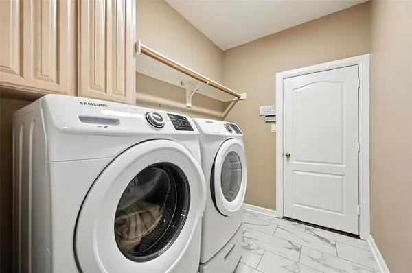 a utility room with dryer and washer