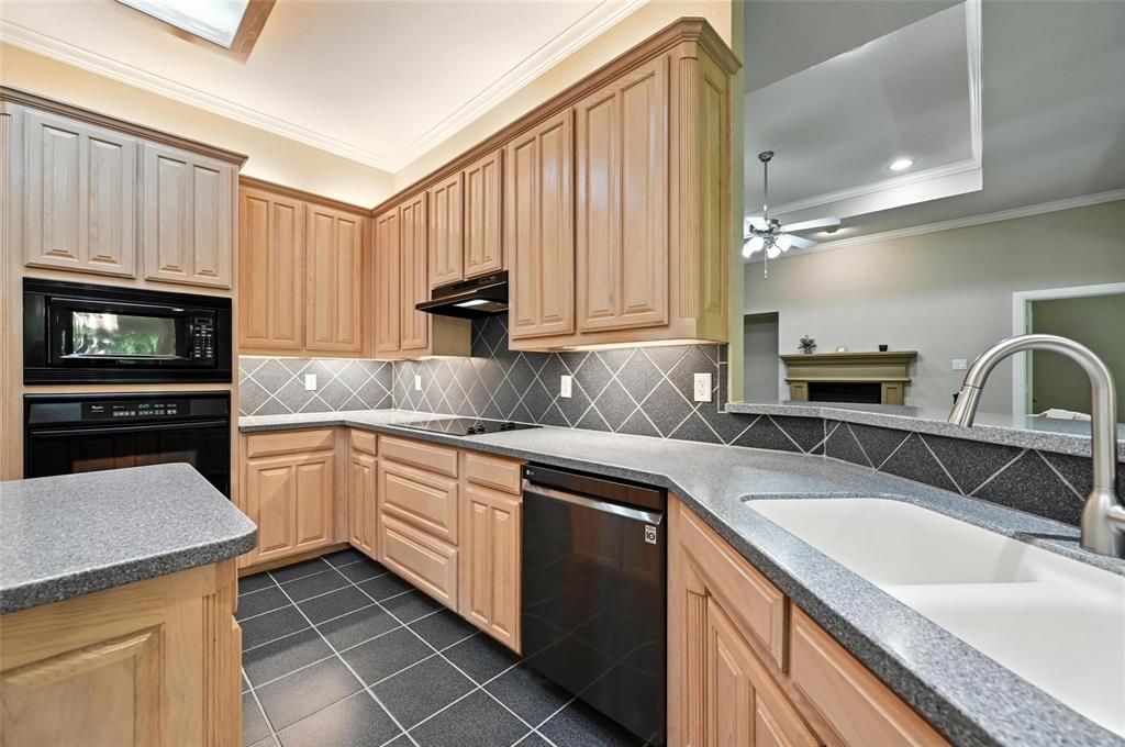 8974 Ranch Bluff Court Benbrook, TX 76126 - Photo 9 of 37 a kitchen with granite countertop a sink stainless steel appliances and cabinets