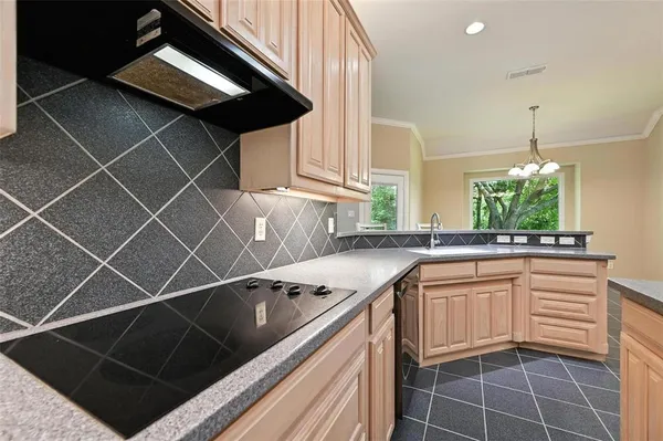 a kitchen that has a sink and a stove