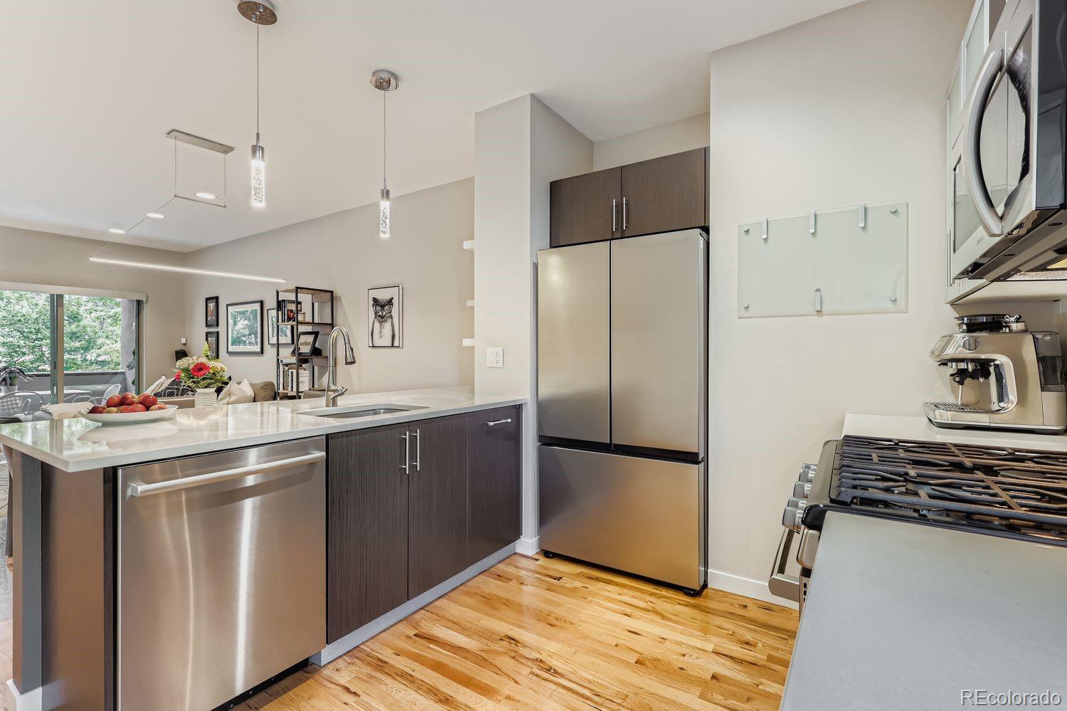2715 Decatur Street Denver, CO 80211 - Photo 12 of 39 a kitchen with stainless steel appliances granite countertop a refrigerator and a sink