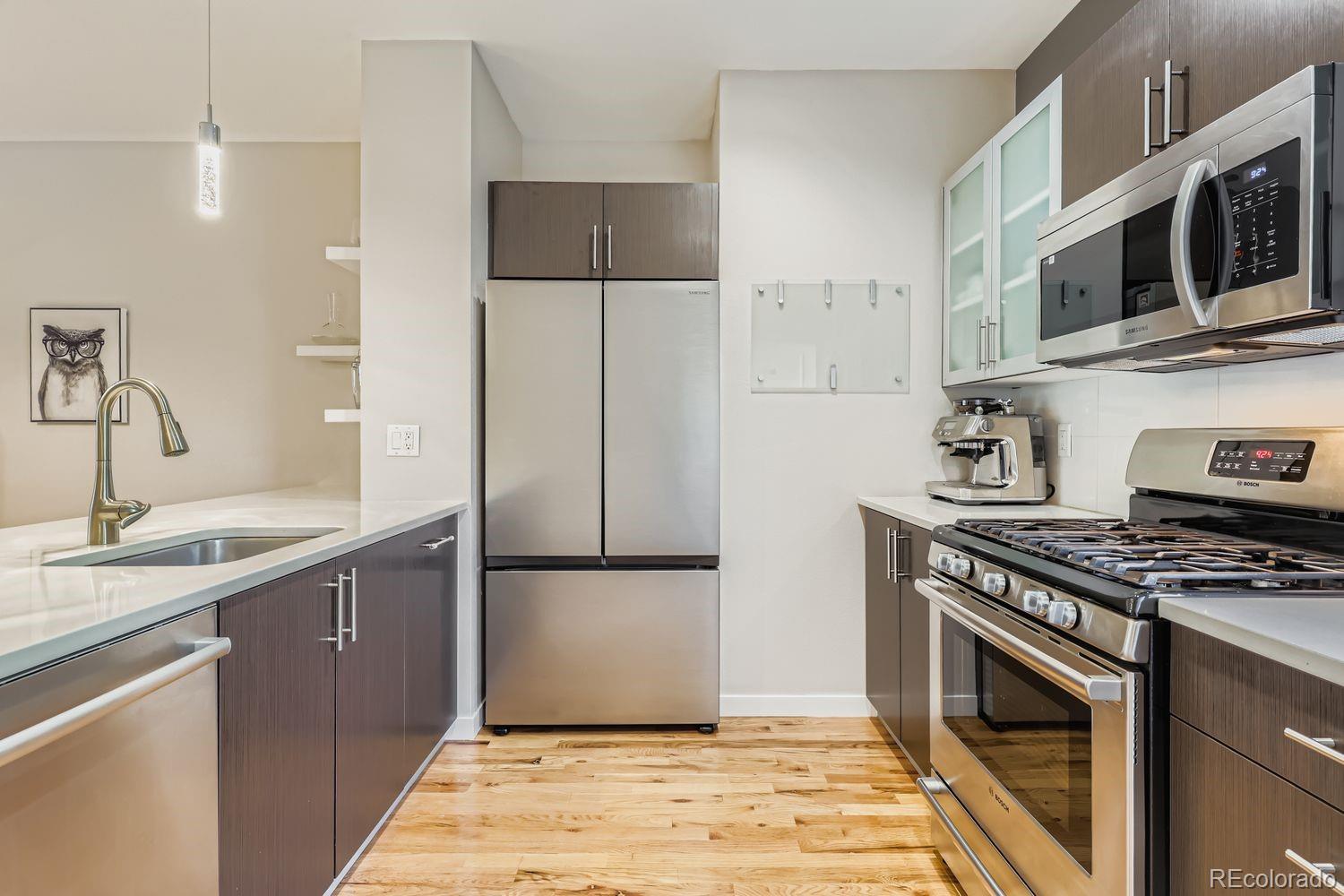 2715 Decatur Street Denver, CO 80211 - Photo 14 of 39 a kitchen with stainless steel appliances granite countertop a stove a refrigerator and a sink