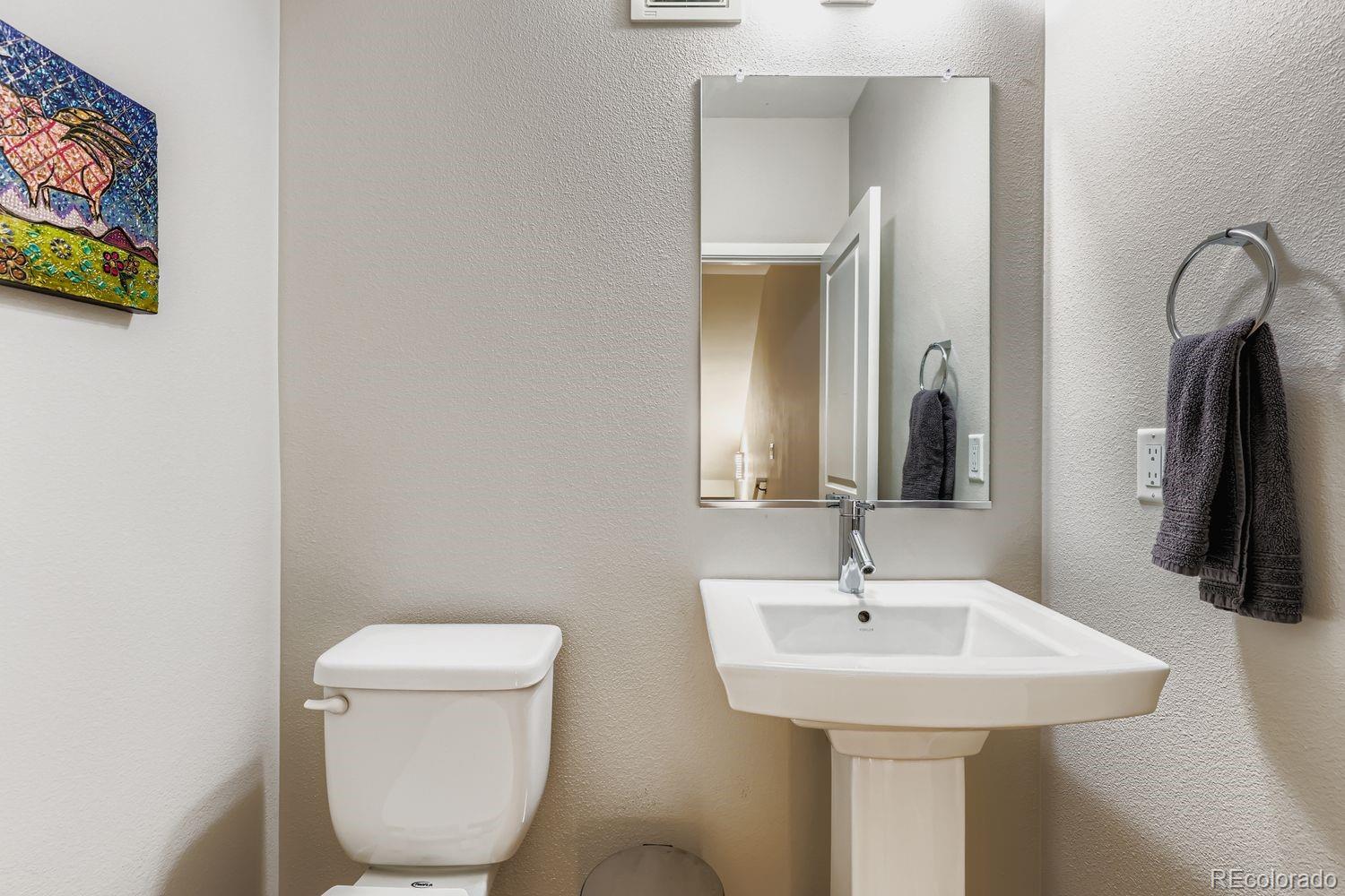 2715 Decatur Street Denver, CO 80211 - Photo 16 of 39 a bathroom with a toilet sink and mirror