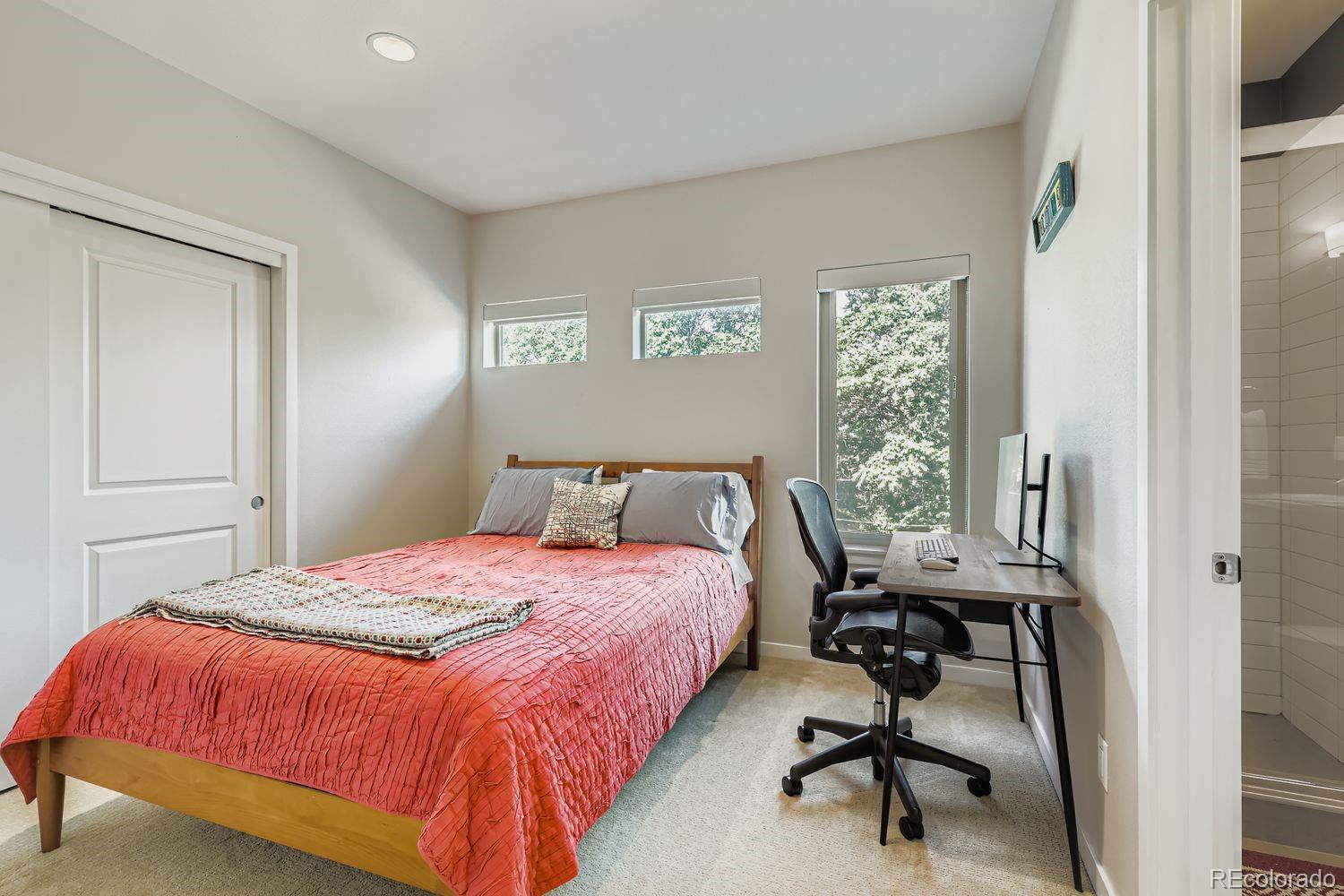 2715 Decatur Street Denver, CO 80211 - Photo 25 of 39 a bedroom with a bed and a table in it