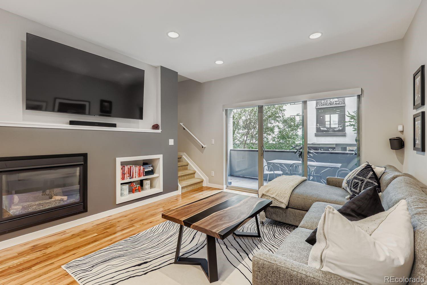 2715 Decatur Street Denver, CO 80211 - Photo 7 of 39 a living room with furniture a flat screen tv and a fireplace