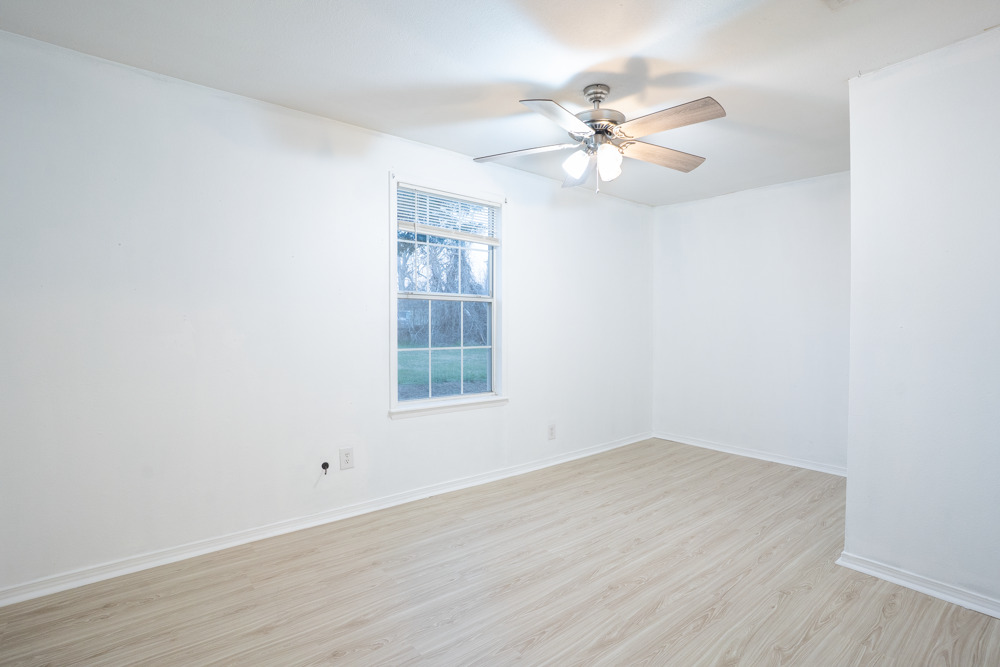 207 Harris Street Elgin, TX 78621 - Photo 13 of 19 an empty room with wooden floor closet and windows