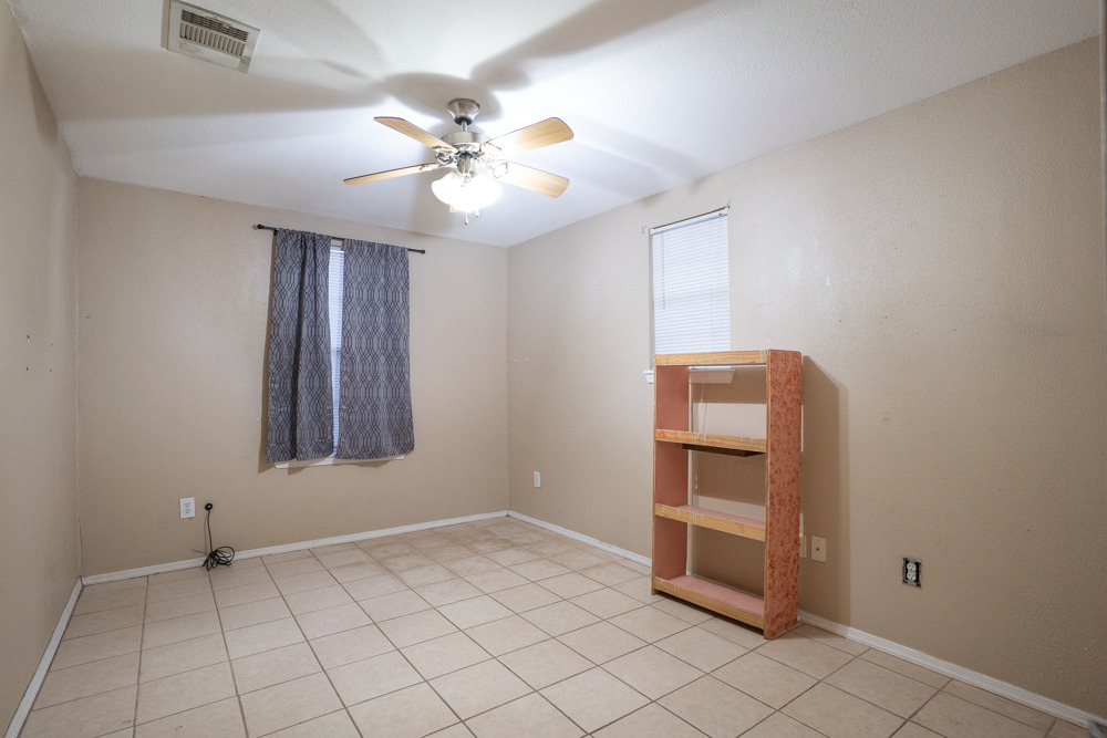 207 Harris Street Elgin, TX 78621 - Photo 14 of 19 a view of an empty room with window and chandelier fan