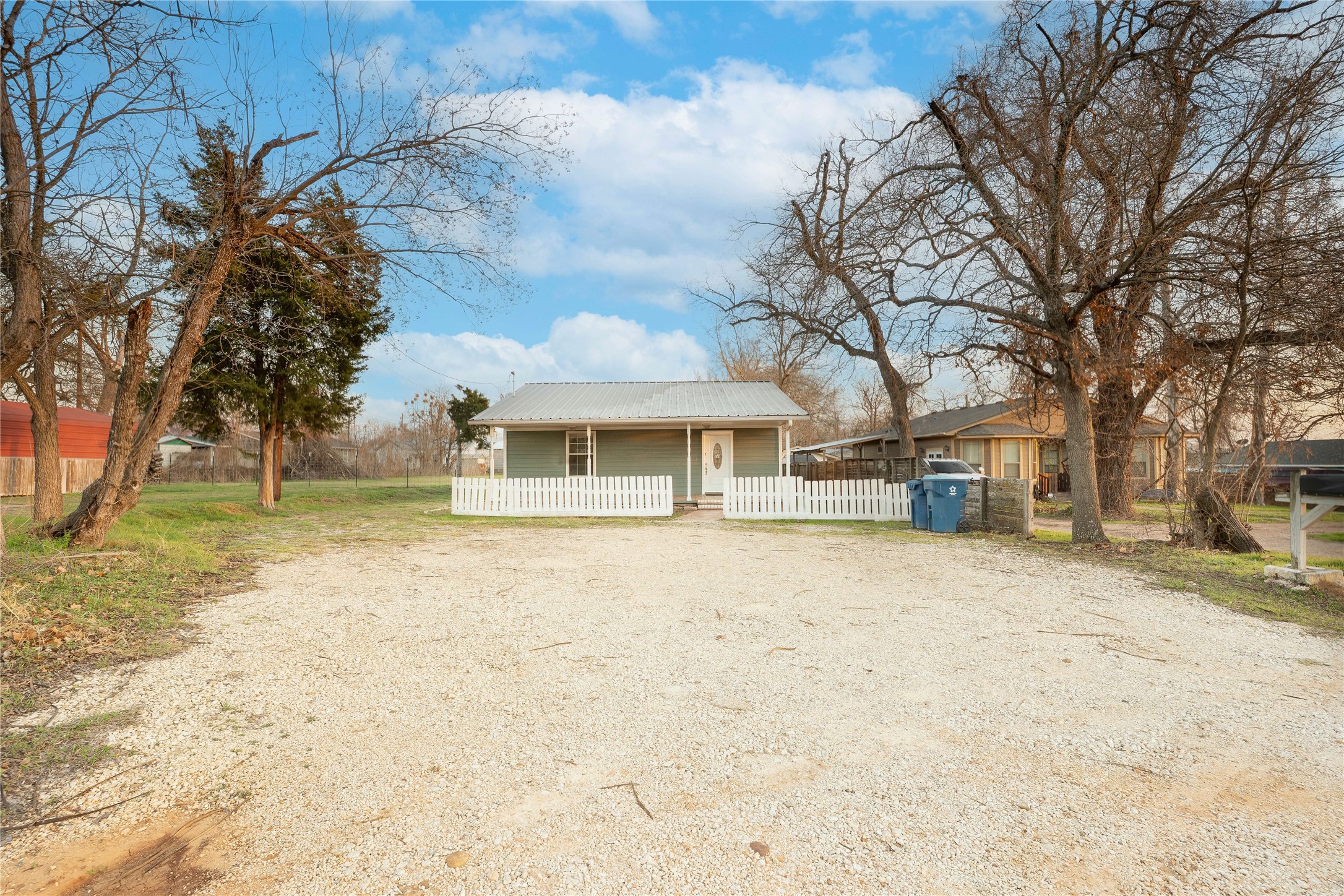 207 Harris Street Elgin, TX 78621 - Photo 2 of 19 a front view of a house with a yard covered with snow