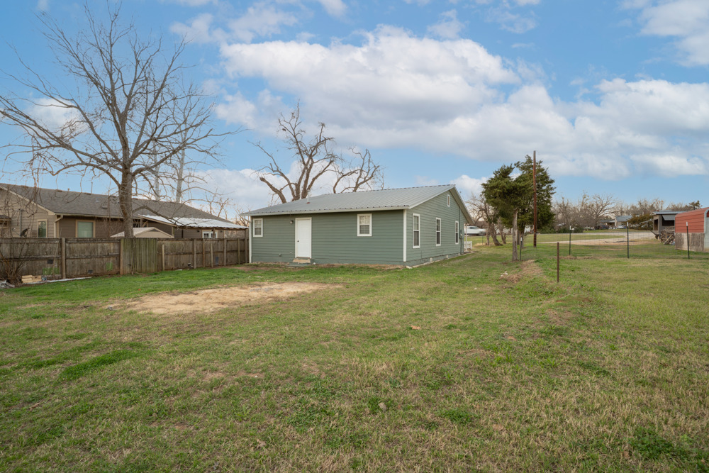 207 Harris Street Elgin, TX 78621 - Photo 6 of 19 a front view of a house with garden
