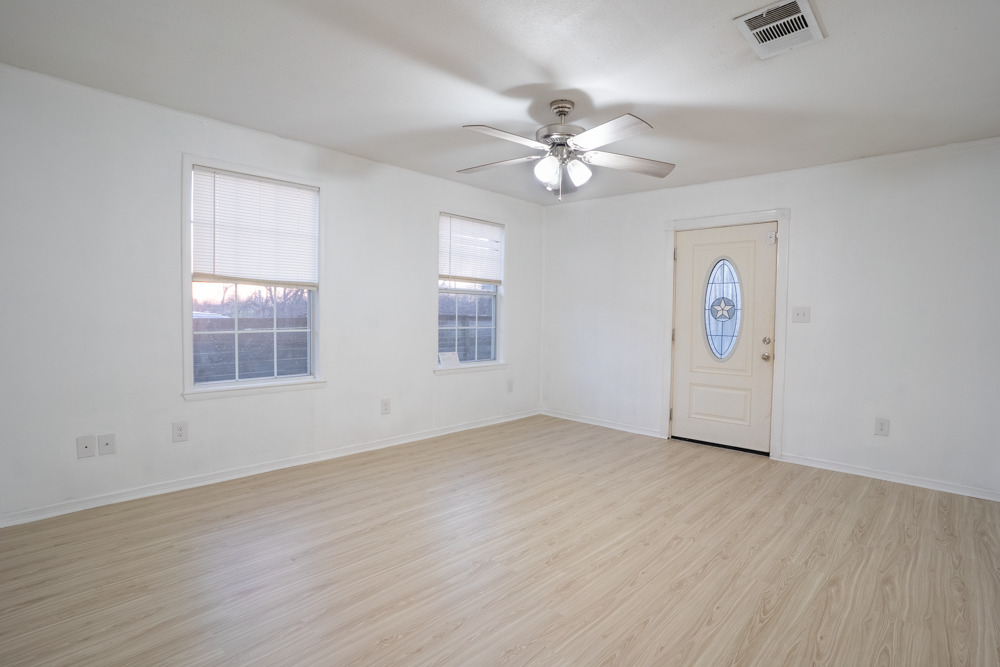 207 Harris Street Elgin, TX 78621 - Photo 7 of 19 an empty room with windows and fan