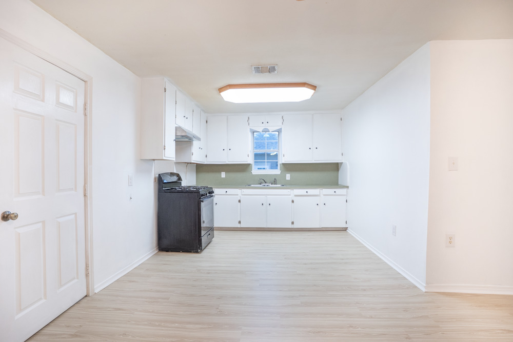 207 Harris Street Elgin, TX 78621 - Photo 10 of 19 a room with a stove and a refrigerator