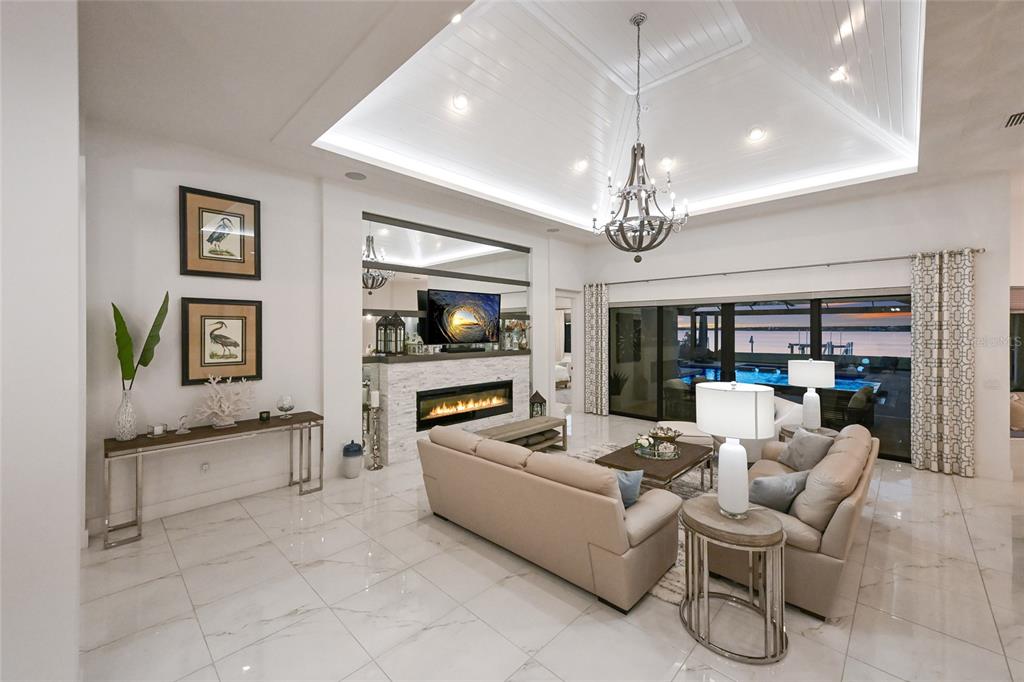 700 Regatta Way Bradenton, FL 34208 - Photo 14 of 78 a living room with furniture and a chandelier