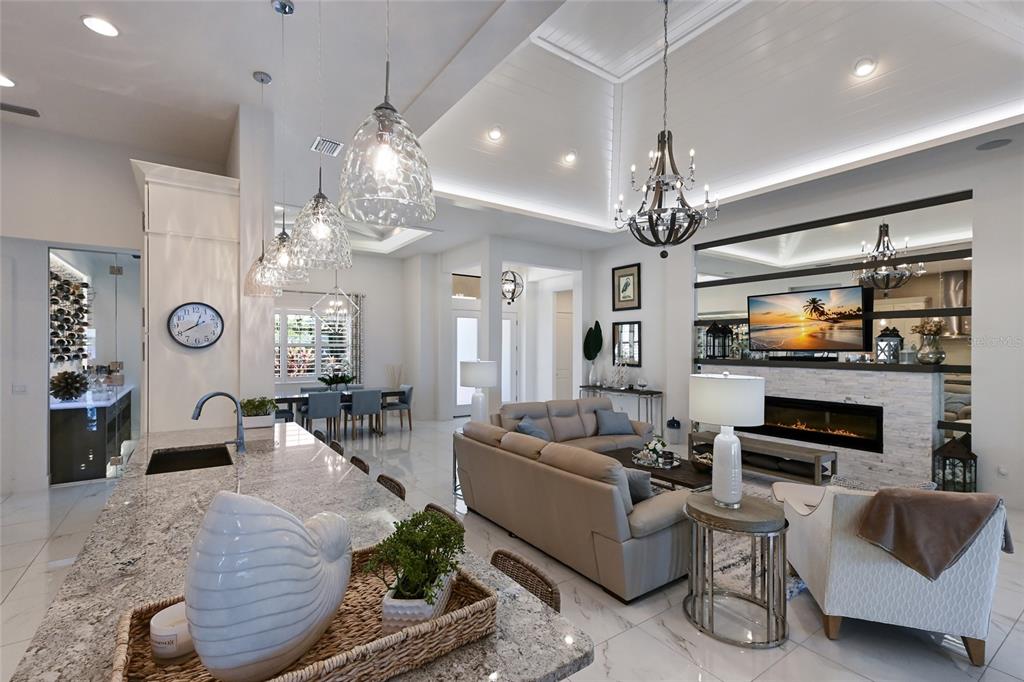 700 Regatta Way Bradenton, FL 34208 - Photo 17 of 78 a living room with fireplace furniture and a chandelier