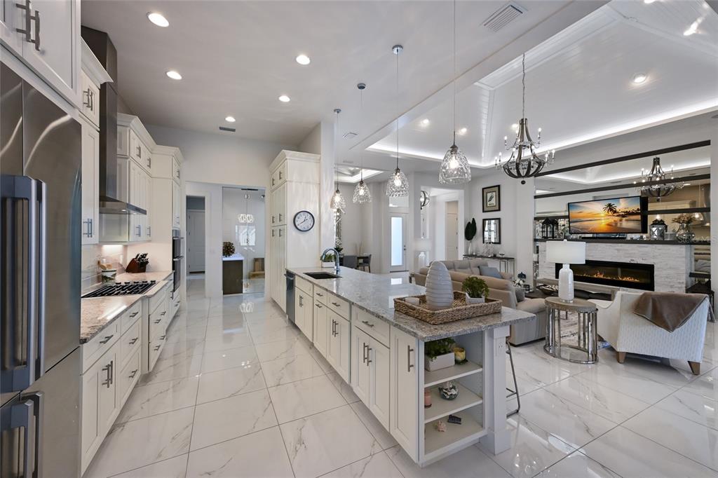 700 Regatta Way Bradenton, FL 34208 - Photo 18 of 78 a large kitchen with kitchen island a large counter top space a sink stainless steel appliances and cabinets