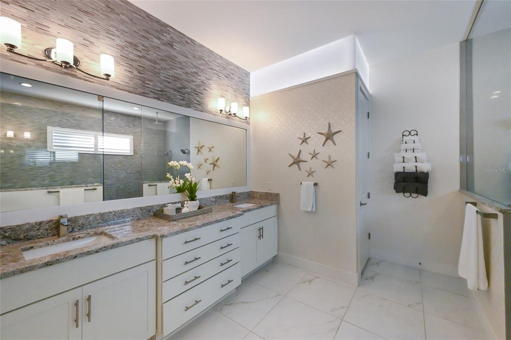 700 Regatta Way Bradenton, FL 34208 - Photo 28 of 78 a bathroom with a granite countertop sink a toilet and a mirror