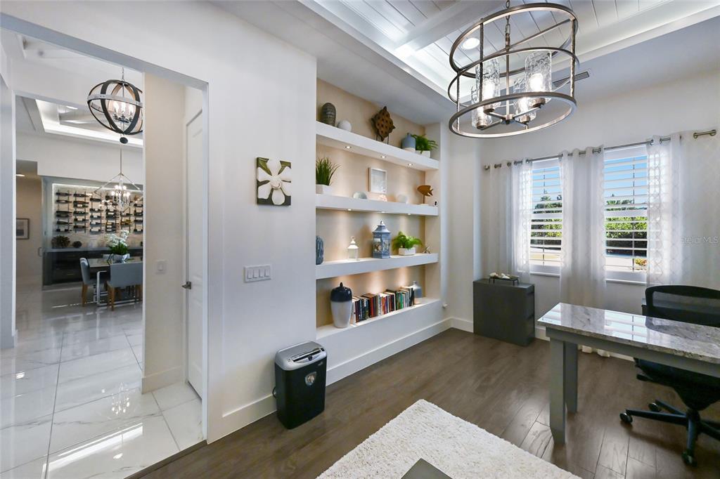 700 Regatta Way Bradenton, FL 34208 - Photo 34 of 78 a view of a livingroom with furniture a chandelier and wooden floor