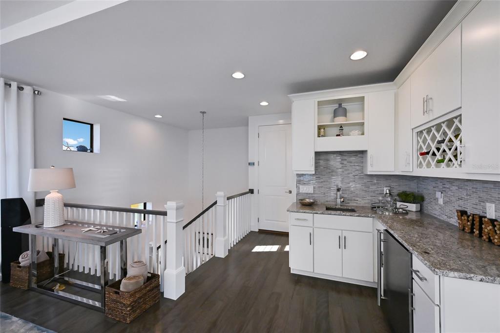 700 Regatta Way Bradenton, FL 34208 - Photo 43 of 78 a kitchen with a sink cabinets and wooden floor