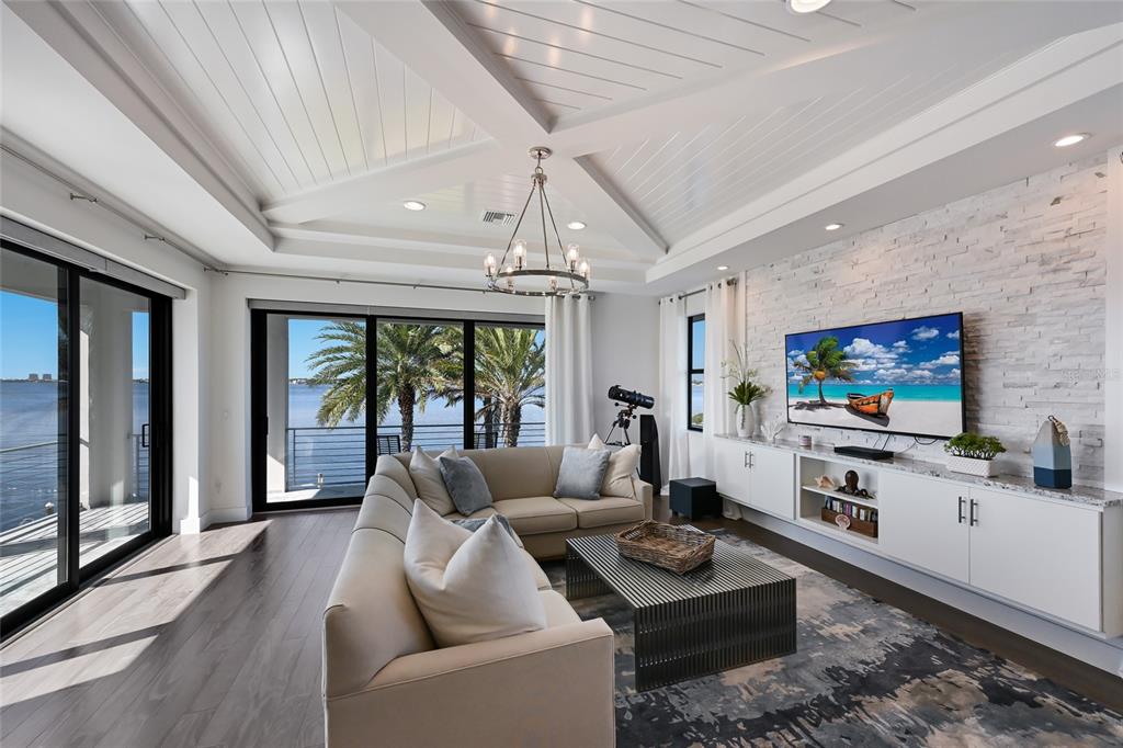 700 Regatta Way Bradenton, FL 34208 - Photo 45 of 78 a living room with furniture a flat screen tv and a large window