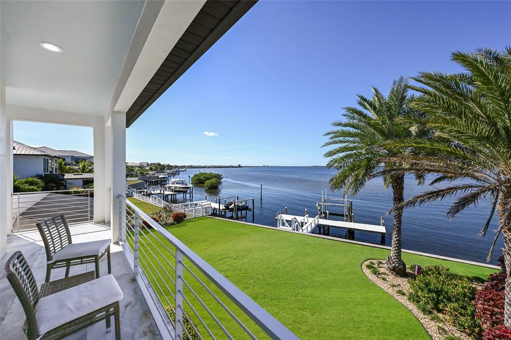 700 Regatta Way Bradenton, FL 34208 - Photo 49 of 78 a view of a chairs and table in patio with a yard