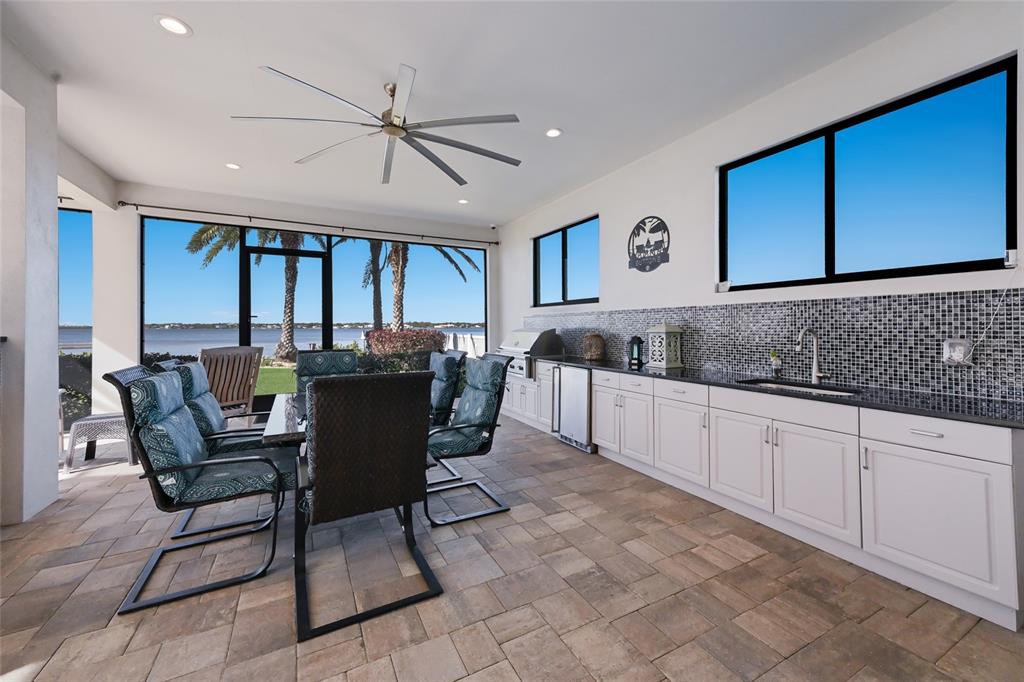 700 Regatta Way Bradenton, FL 34208 - Photo 62 of 78 a kitchen with a dining table chairs and white cabinets
