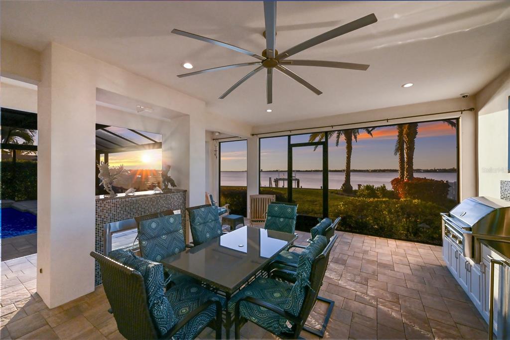 700 Regatta Way Bradenton, FL 34208 - Photo 63 of 78 a dining room with furniture a chandelier and a floor to ceiling window