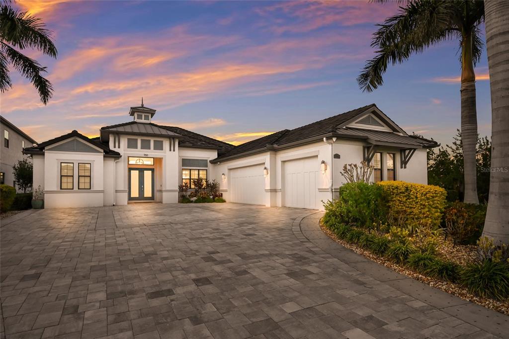 700 Regatta Way Bradenton, FL 34208 - Photo 77 of 78 a front view of a house with a garden and trees