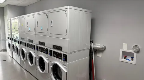 a living room with furniture pool table and a large window