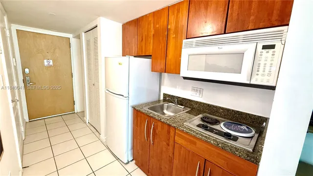 a white refrigerator freezer sitting inside of a kitchen