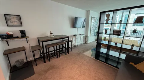 a bed room with a bed tv and a chair