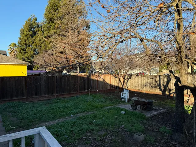 a view of backyard with swimming pool