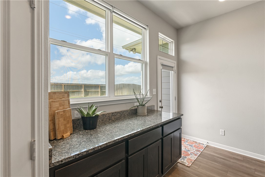 4746 Holm Oak Road College Station, TX 77845 - Photo 13 of 25 a kitchen with granite countertop a sink and a window