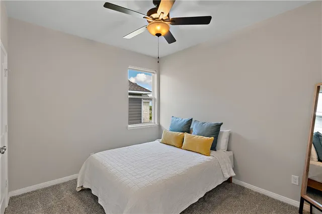 a bedroom with a bed a window and closet