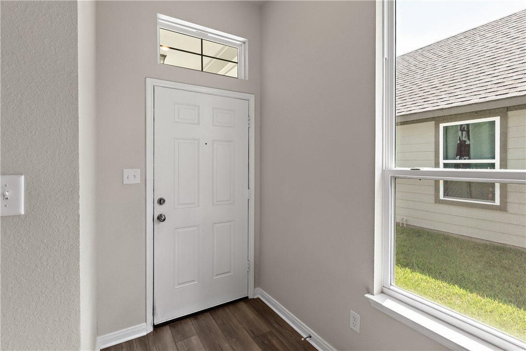 4746 Holm Oak Road College Station, TX 77845 - Photo 4 of 25 a view of a hallway with wooden floor and cabinet