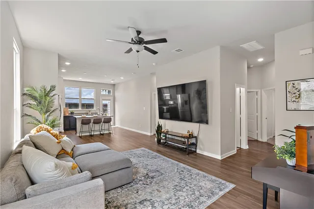 a living room with furniture and wooden floor