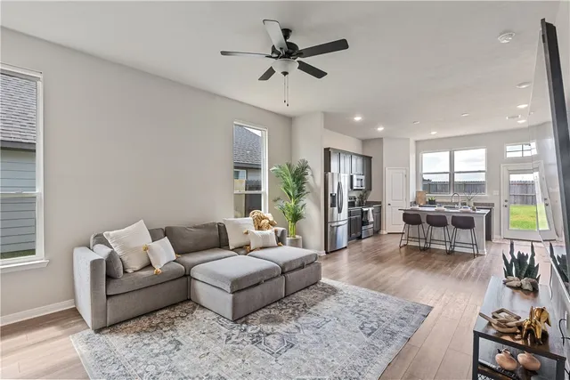 a living room with furniture and wooden floor