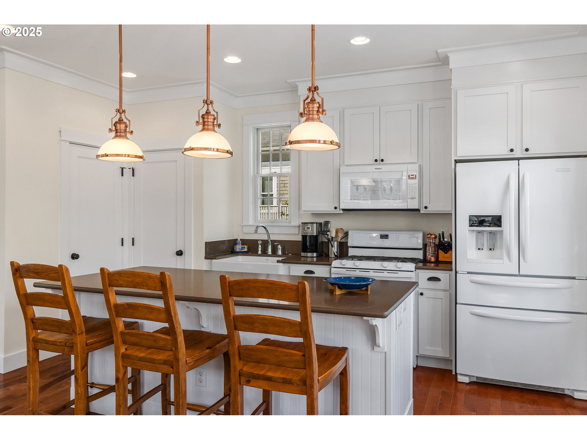 81 Compass Street Pacific Beach, WA 98571 - Photo 13 of 47 a kitchen with stainless steel appliances a white table chairs and a refrigerator