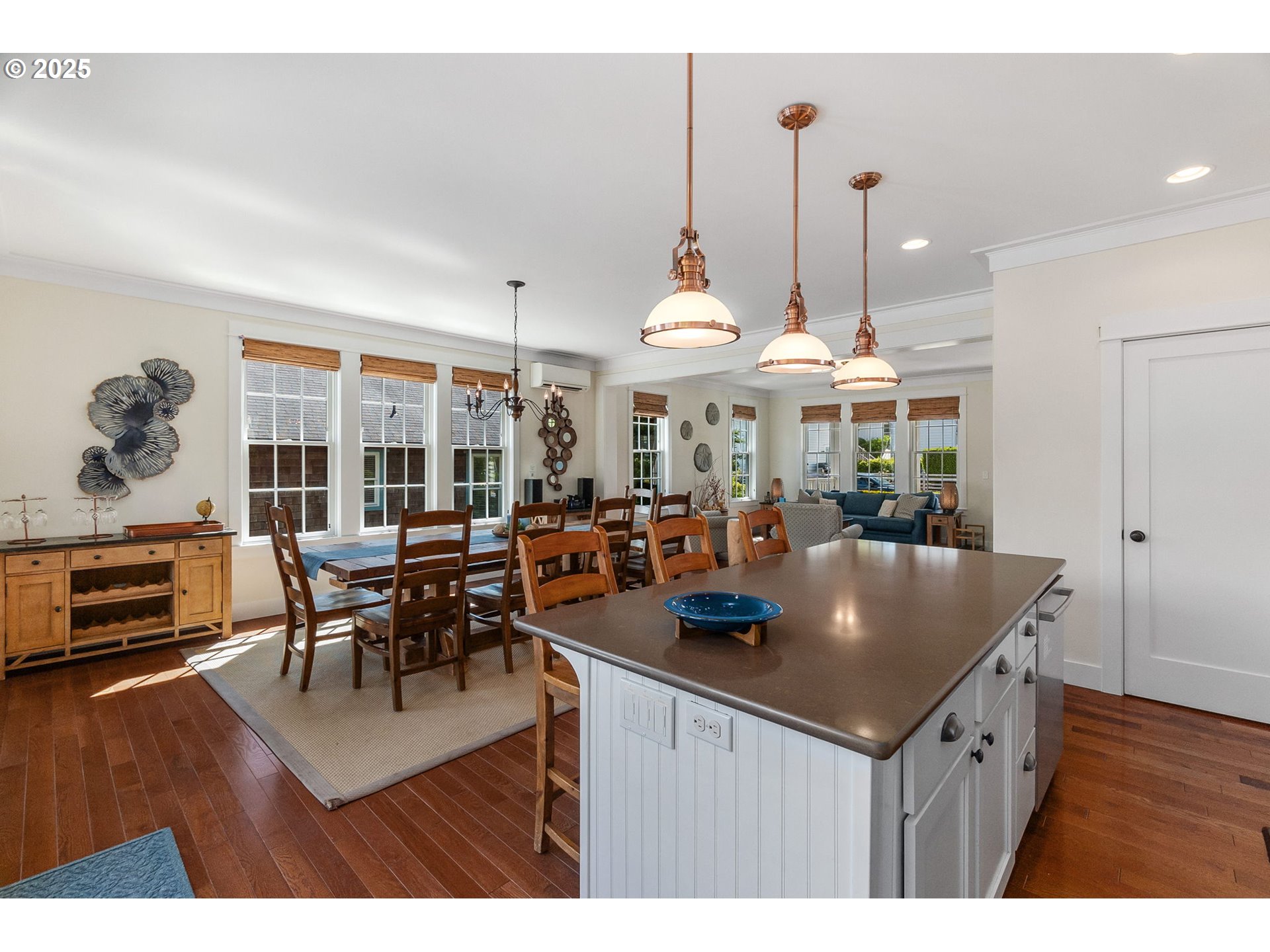 81 Compass Street Pacific Beach, WA 98571 - Photo 14 of 47 a view of dining room and livingroom with furniture wooden floor a rug a fireplace and a chandelier