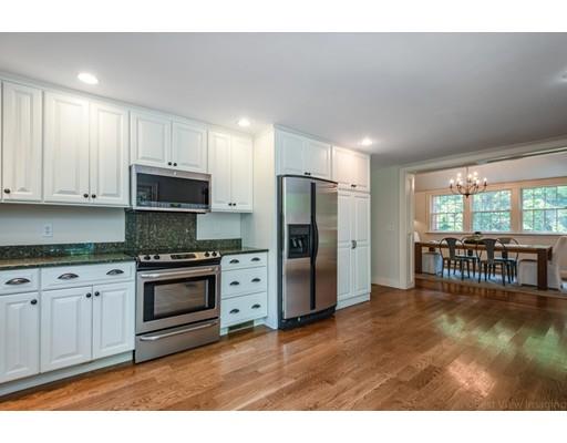 1001 Depot Road Boxborough, MA 01719 - Photo 12 of 34 a kitchen with stainless steel appliances granite countertop a stove a refrigerator a sink a dining table and chairs with wooden floor