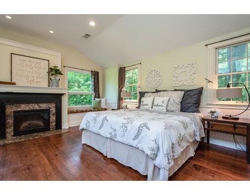1001 Depot Road Boxborough, MA 01719 - Photo 21 of 34 a spacious bedroom with a bed and a fireplace