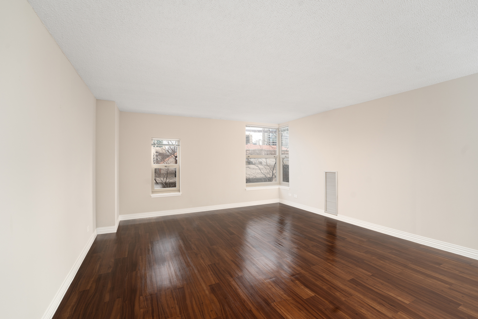 100 West Chestnut Street, Unit 503 Chicago, IL 60610 - Photo 14 of 18 an empty room with wooden floor and windows
