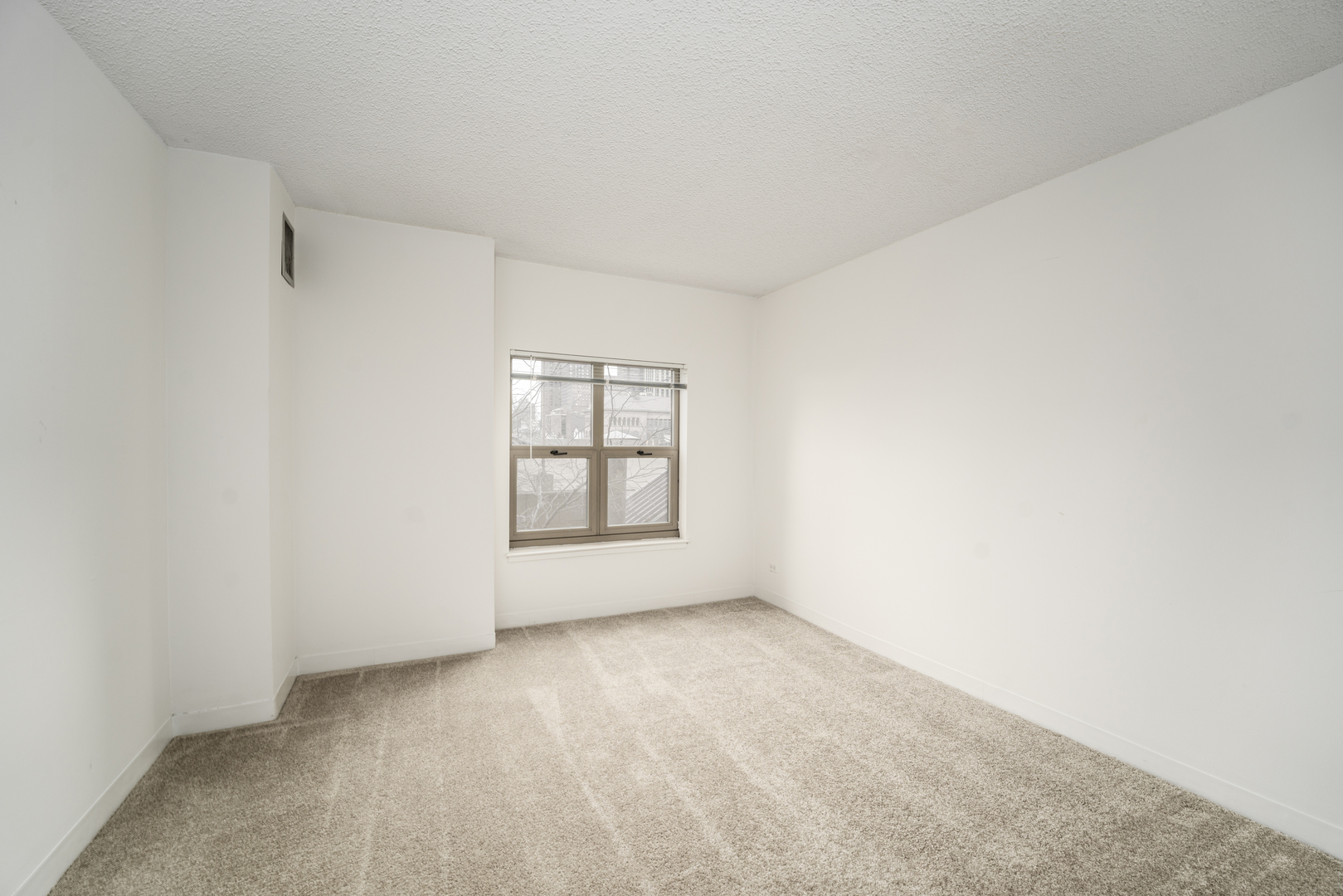 100 West Chestnut Street, Unit 503 Chicago, IL 60610 - Photo 16 of 18 a view of an empty room with a window