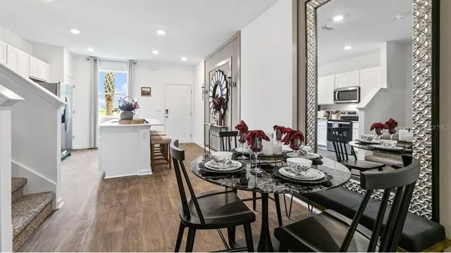 a view of a dining room with furniture and wooden floor