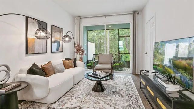 a living room with furniture fireplace and a large window
