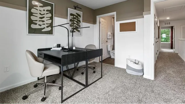 a view of a workspace with furniture