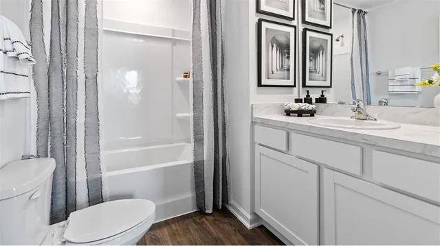 a bathroom with a toilet a sink and a mirror