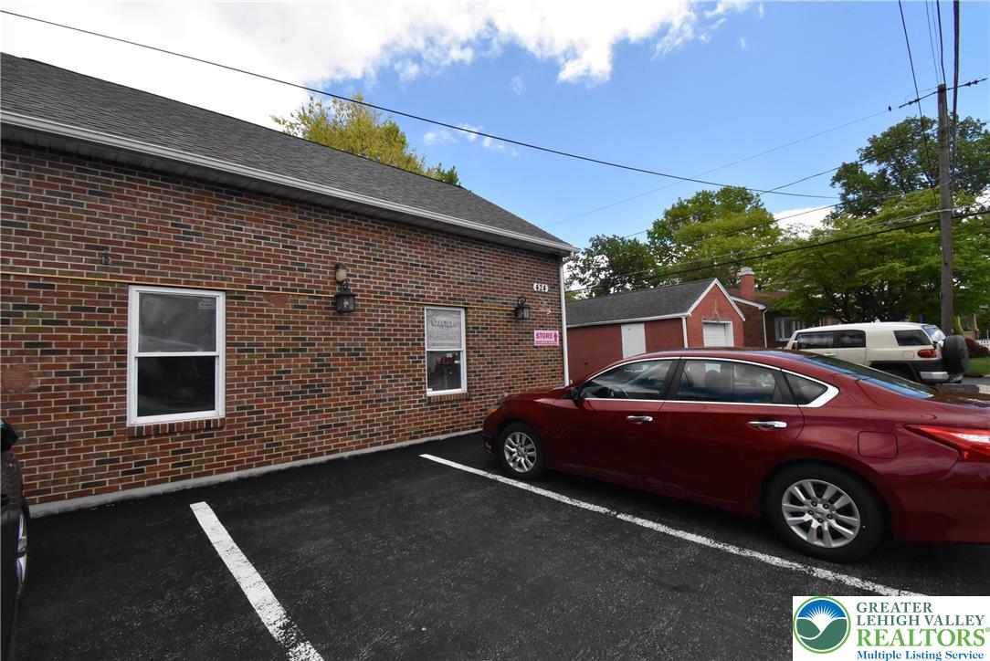 424 Grape Street Whitehall, PA 18052 - Photo 16 of 56 This commercial building features a brick exterior and a paved parking lot.