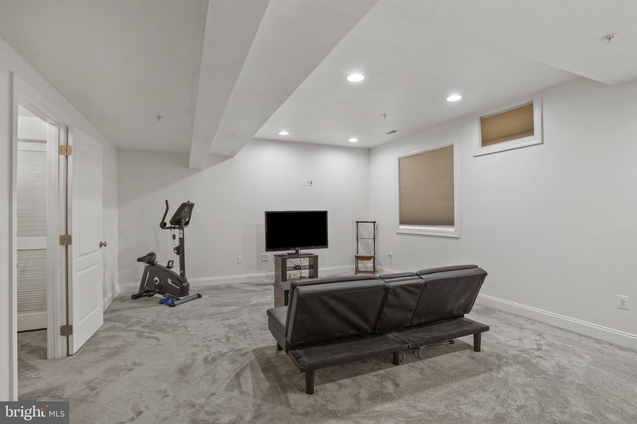 7609 Elmcrest Road Hanover, MD 21076 - Photo 12 of 37 a living room with furniture and a flat screen tv