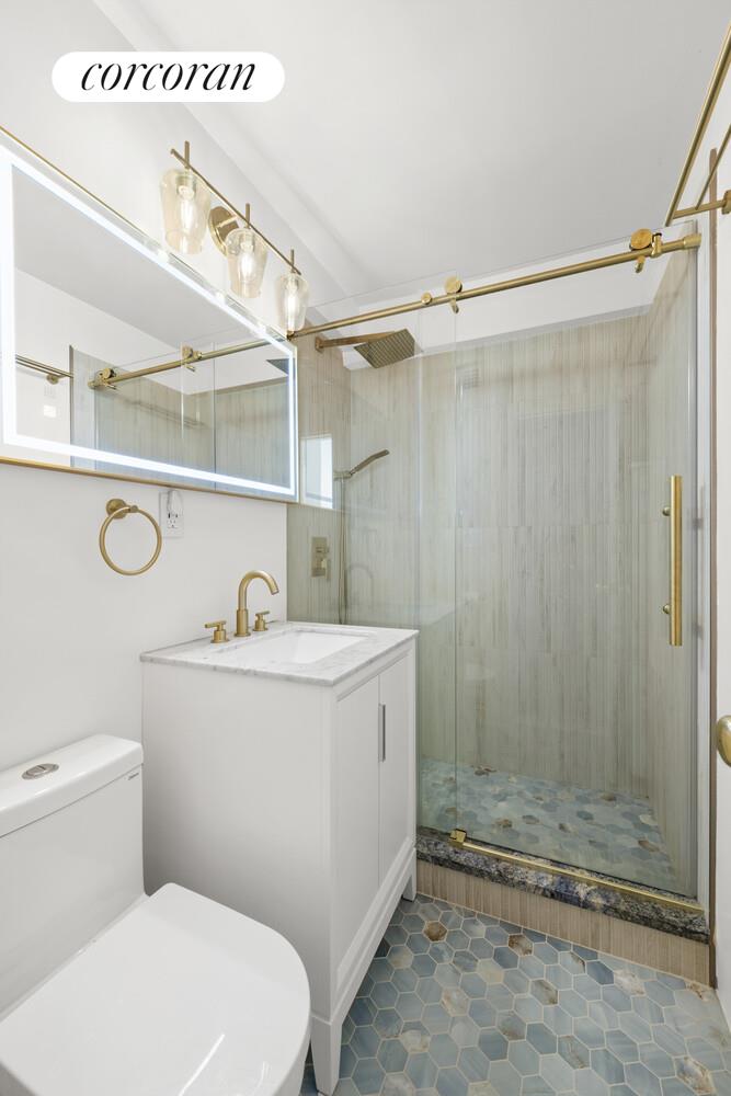 520 East 76th Street, Unit 4H Manhattan, NY 10021 - Photo 6 of 10 a bathroom with a sink a toilet and shower