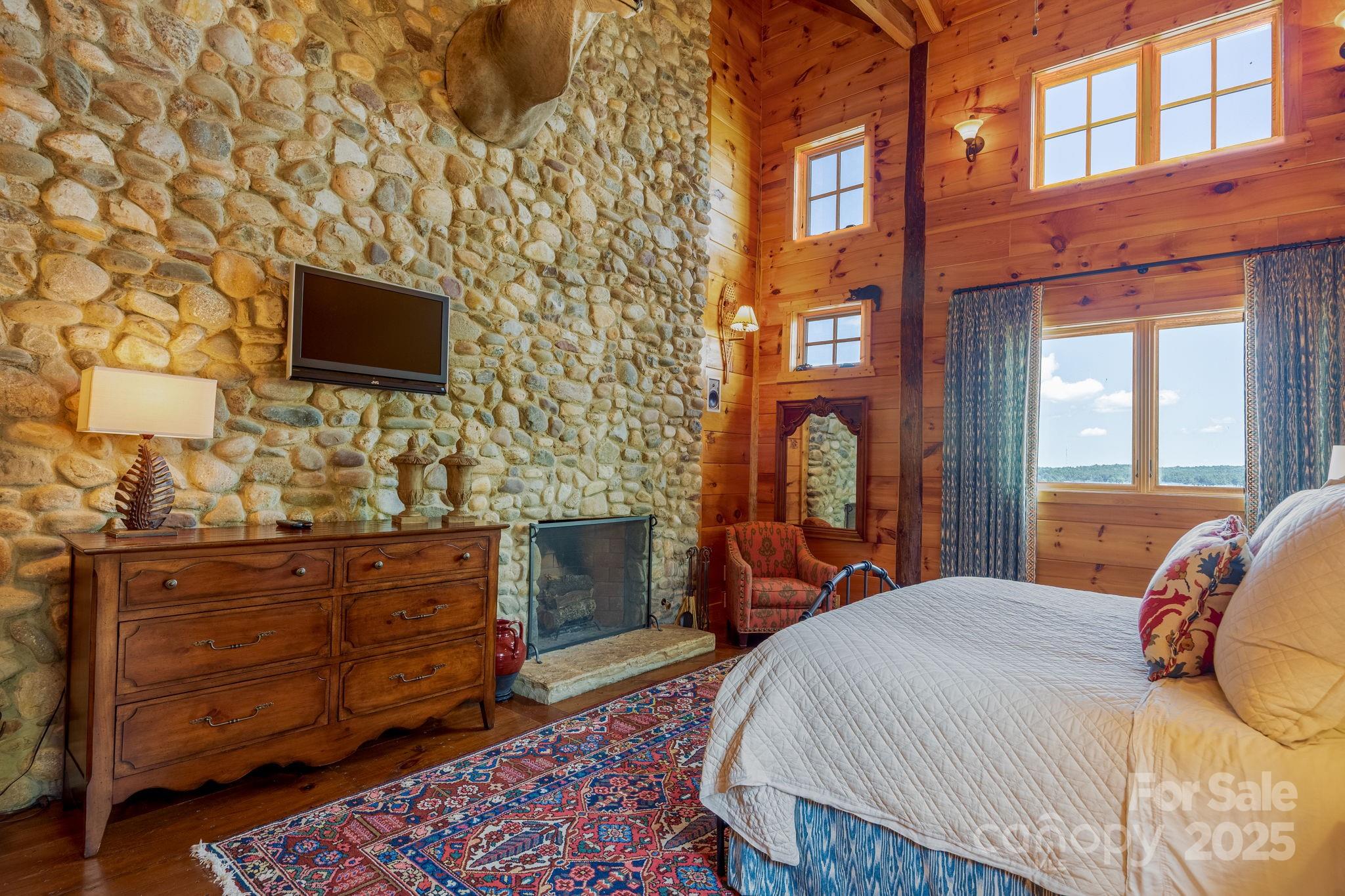 197 Smooth Rock Point Ridgeway, SC 29130 - Photo 25 of 48 a bedroom with a bed and a flat screen tv